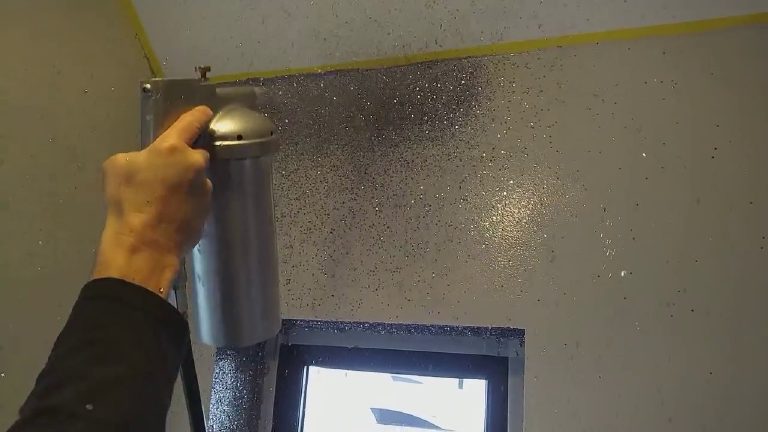 Glitter flakes flying as the first pass goes onto the wall above the window