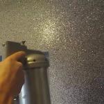 Spraying the glitter flakes onto the porch wall