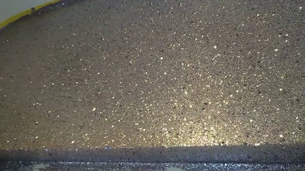 The gun metal glitter catching the light up close