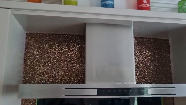 Two panels of the finish either side of the extractor hood, under the shelves