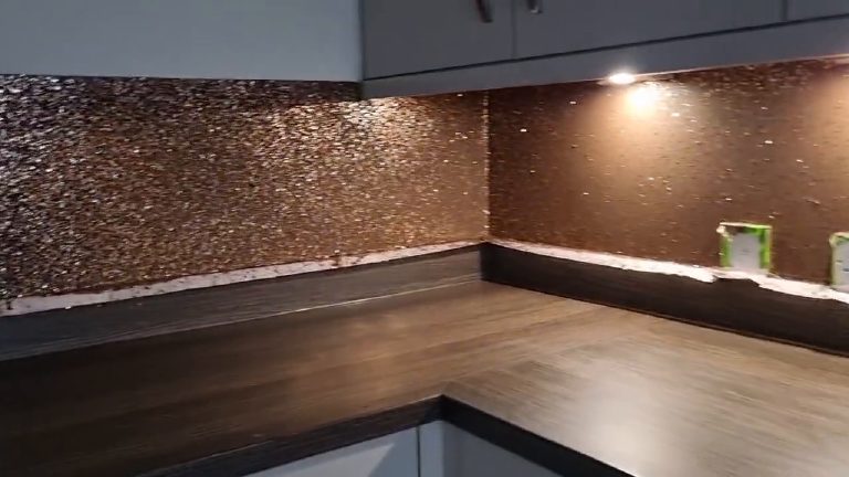 The corner of the splashback with a downlight catching the copper flake