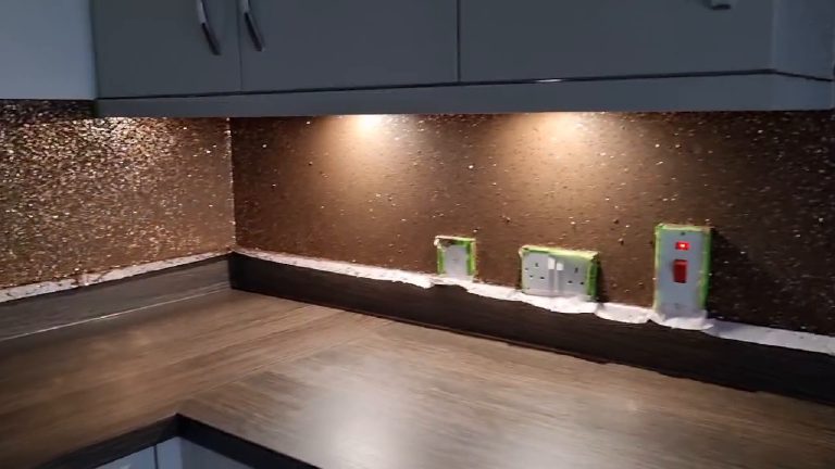 The splashback along the run with the sockets and switch still taped off in green