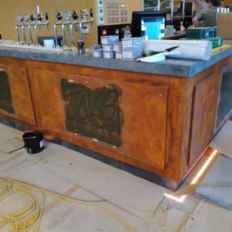 The bar with logo freshly stencilled, taps and till going in