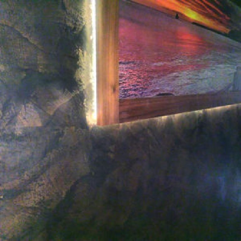 Black Marmorino wall holding the light from a backlit frame
