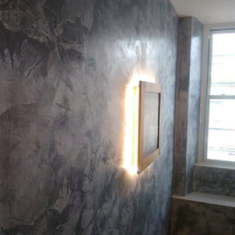 Grey Marmorino wall with a backlit frame beside the window