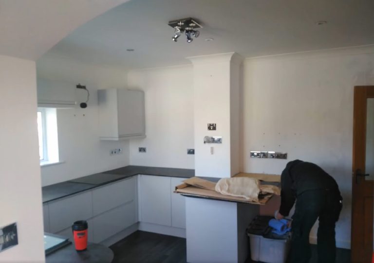 The plain white kitchen before the transformation, work underway