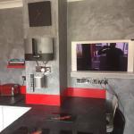 The finished kitchen in one view — Marmorino walls, red accents, breakfast bar