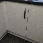 The base units in their new speckled finish under the dark worktop