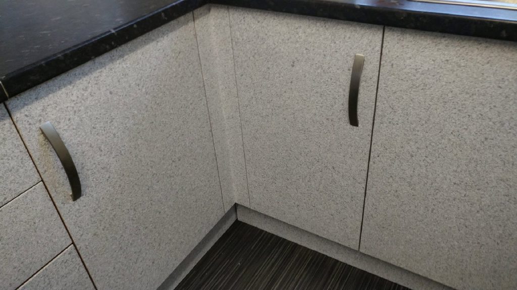 The base units in their new speckled finish under the dark worktop
