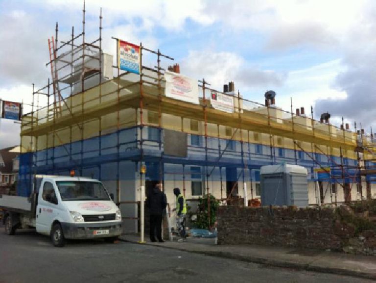 Photographs showing the extensive scaffolding required and the existing underlying Peel sandstone substrate