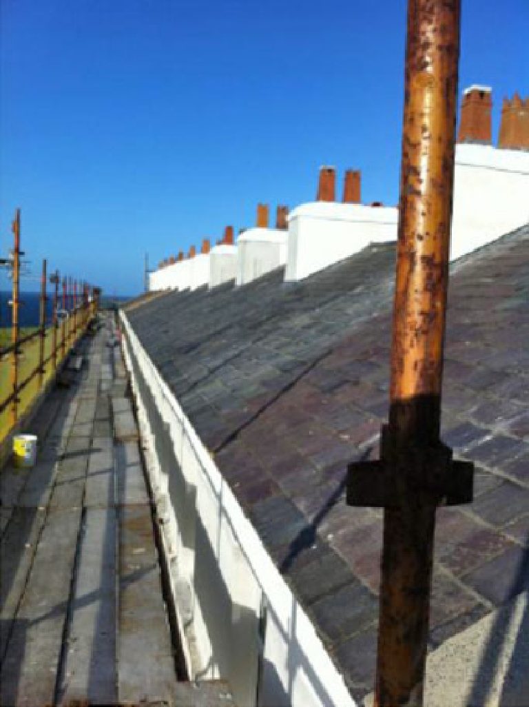 Photographs showing the extensive scaffolding required and the existing underlying Peel sandstone substrate