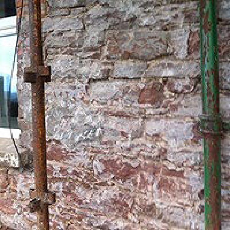 Photographs showing the extensive scaffolding required and the existing underlying Peel sandstone substrate