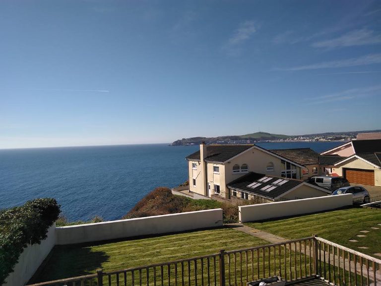 The property seen from along the headland above the sea