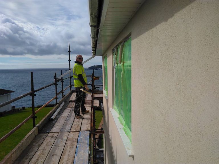 Taping out the windows on the scaffold before rendering