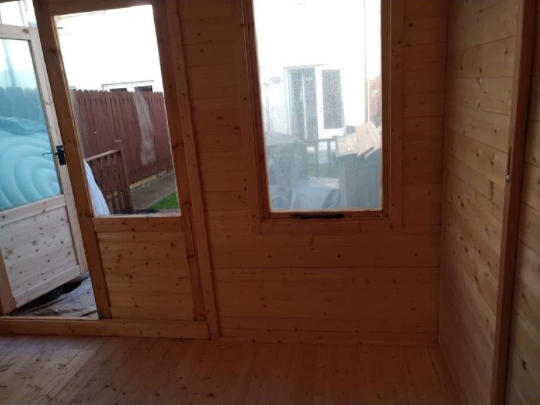 The bare timber corner by the doors before spraying