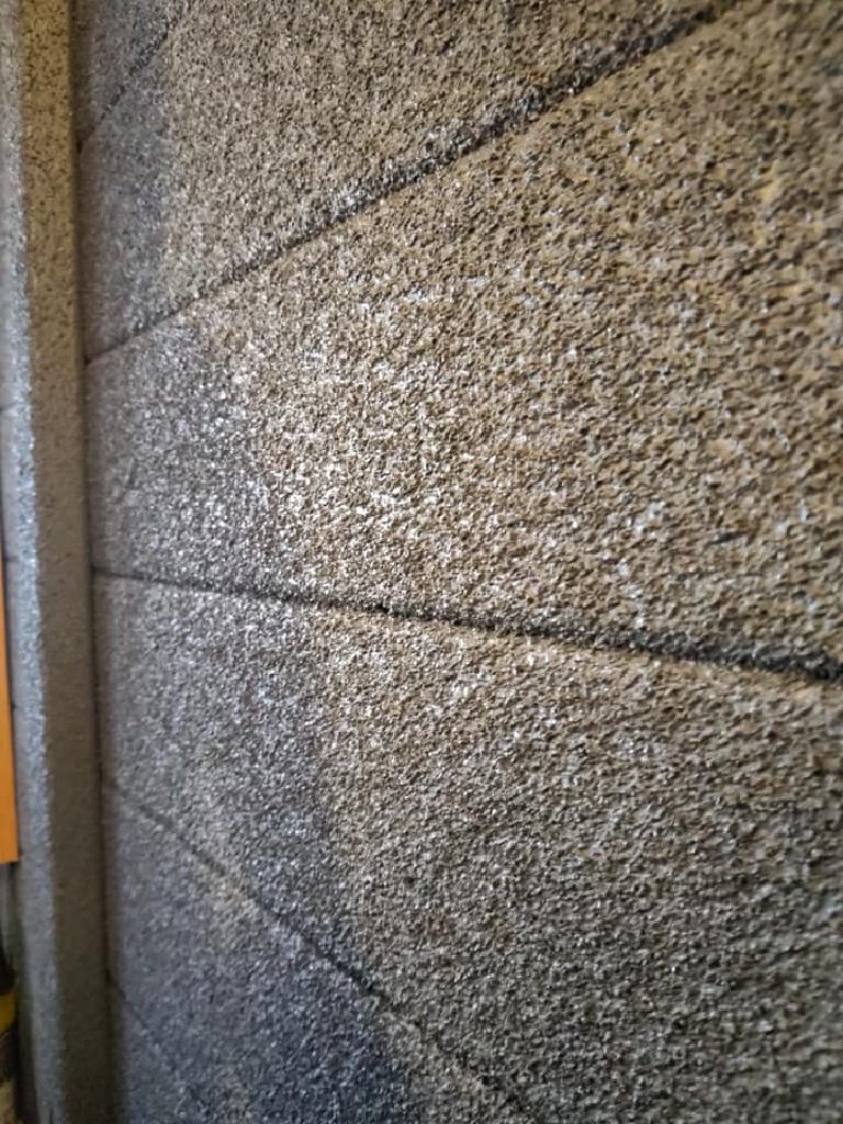 The sprayed cork texture up close, catching the daylight