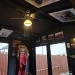 The finished man cave in use, with racing leathers, framed prints and a ceiling fan