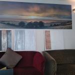 Sample boards on display in the Mannin Hotel lounge beneath the panoramic landscape print