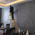 Finishing touches to the textured sparkle wall in the restaurant