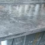 The sample worktop in slate grey MicroCement, its edge returning down the side