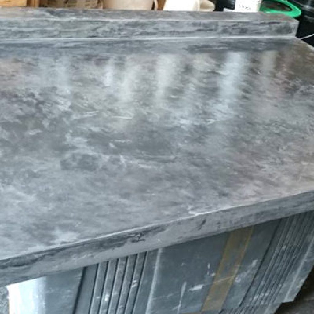 The sample worktop in slate grey MicroCement, its edge returning down the side