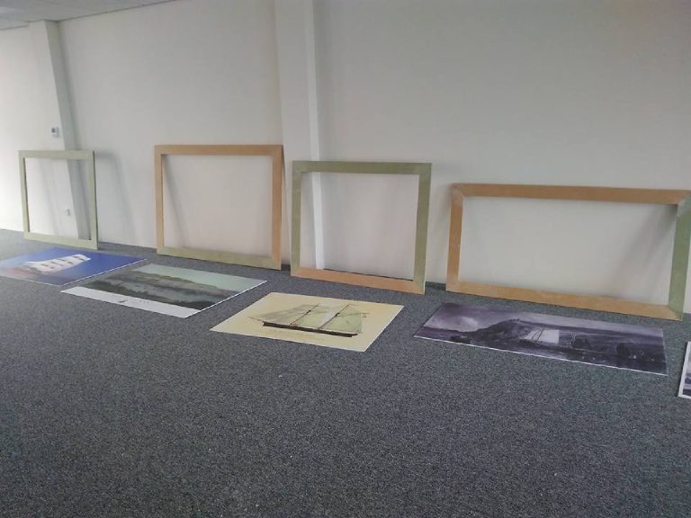 Bare MDF frames lined up with the enlarged prints