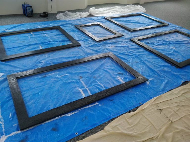 The frames coated in black MicroCement on the tarpaulin