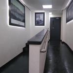 The entrance hall with backlit frames either side