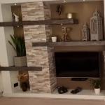 The whole feature wall, microcement shelves running across the stone