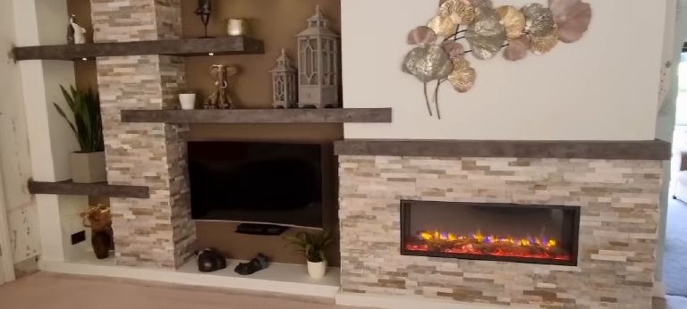 The stone-clad feature wall with the recessed television and linear fire