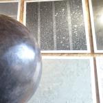 The finished slate-grey microcement sphere, polished to a sheen