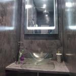 The finished basin nook — LED mirror, glass bowl and MicroCement walls