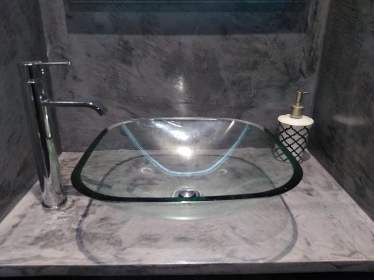 Glass basin sitting on a MicroCement vanity top