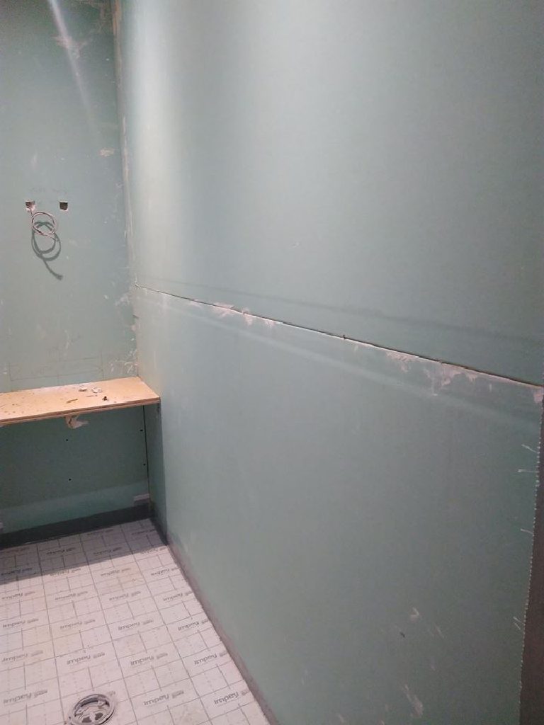 Moisture-resistant board lining the rest of the room