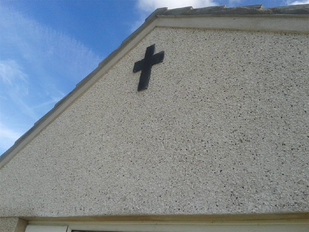 Fresh pebbledash detail at the window, churchyard beyond