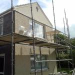 The gable cross in fresh white pebbledash