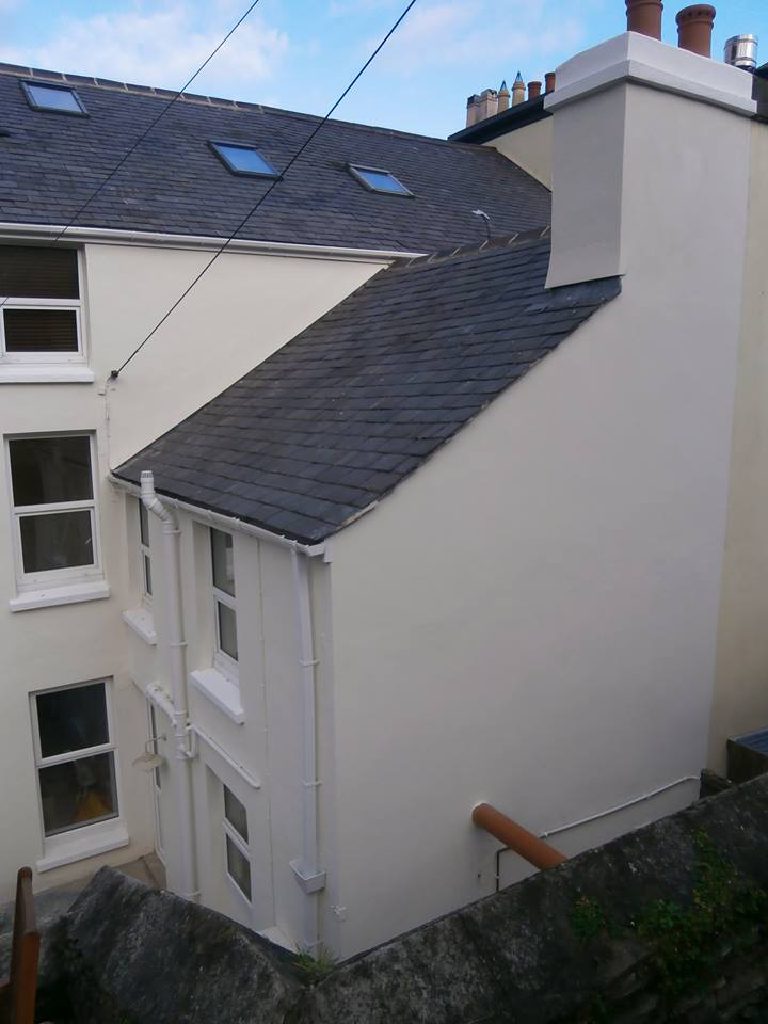 The rear of the house from above, slate roofs and the rendered chimney stack