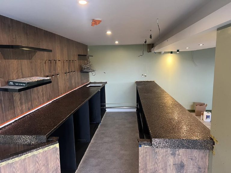 Both bar tops finished, servery on the right and back bar on the left, room still being fitted out