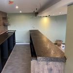 Both runs of bar top finished, the servery on the right and the back bar on the left