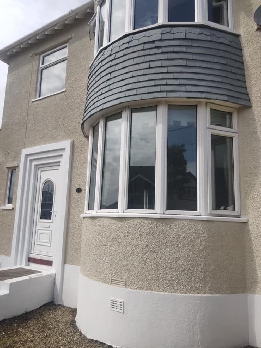The curved bay after the work, cork render taken round it in one even surface