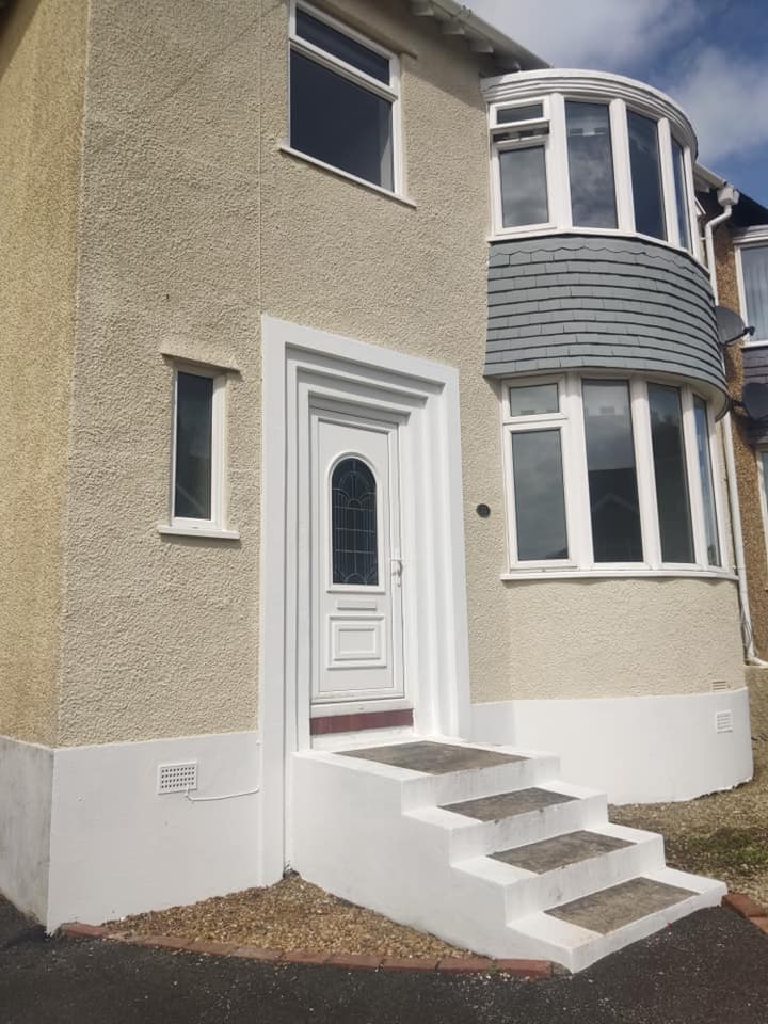 The front door and steps after the work, the render cut in tight to the door surround