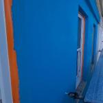The turquoise Light Weight Render System on the upper storey before any painting, seen along the scaffold