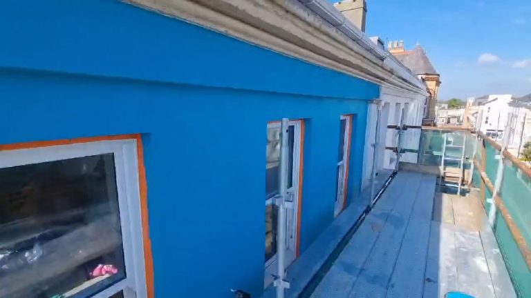 The finished base coat along the top floor, looking down the scaffold towards the town