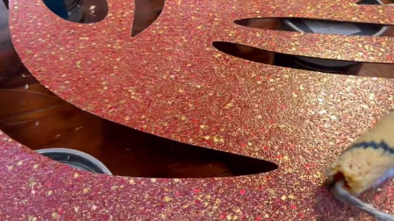 Close view of the glitter flake — red, gold and cream over rose