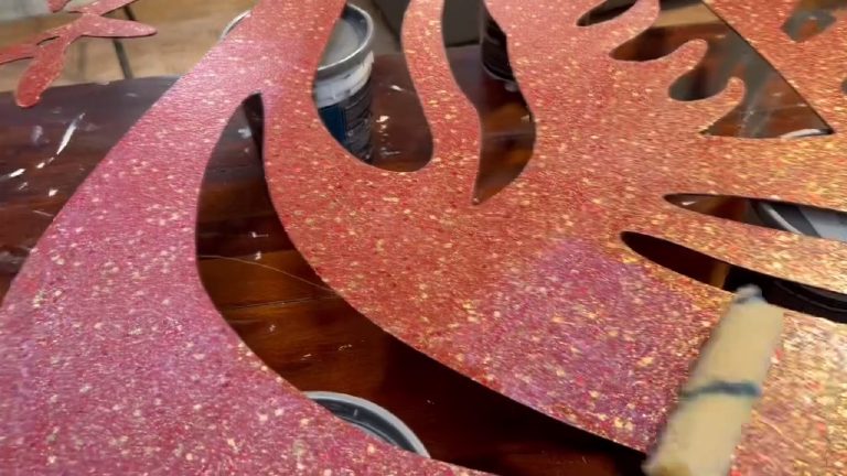 The roller running over the glitter, working round the cut-outs