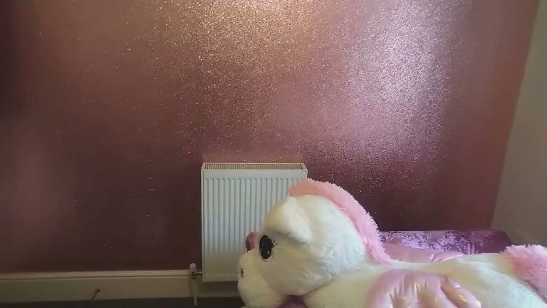 The finished pink wall with a fluffy unicorn keeping watch