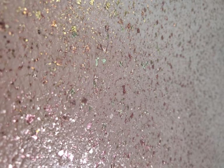 The pink glitter up close, flecks catching the light