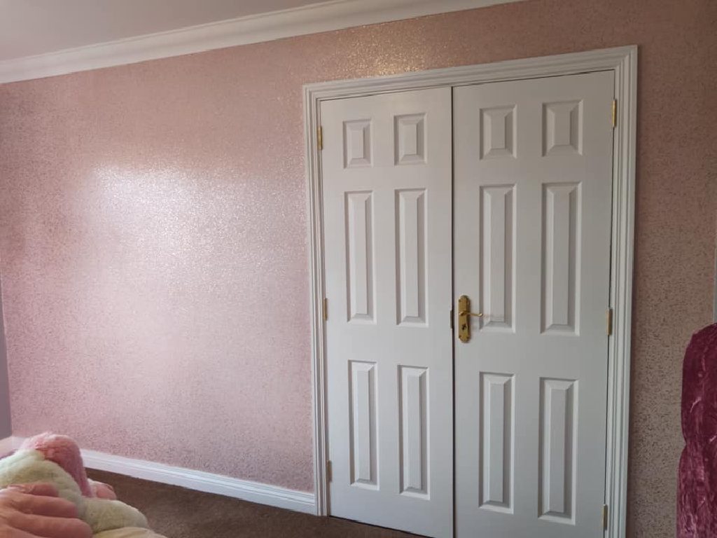The pink glitter walls around the white double doors