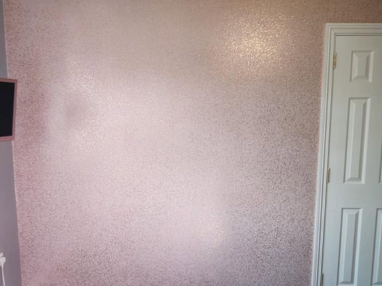 The pink glitter wall seen square on, door to the right
