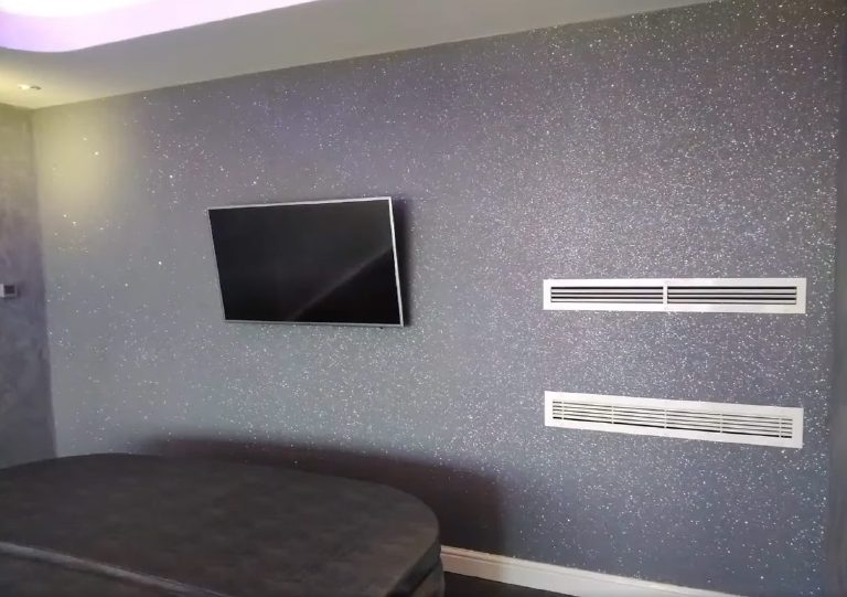 The Cassiopea back wall sparkling around the wall-mounted TV
